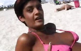 Graceful brunette gives her pussy away freely at a beach